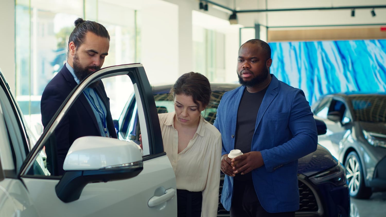 Couple in a car showrrom with sales person
