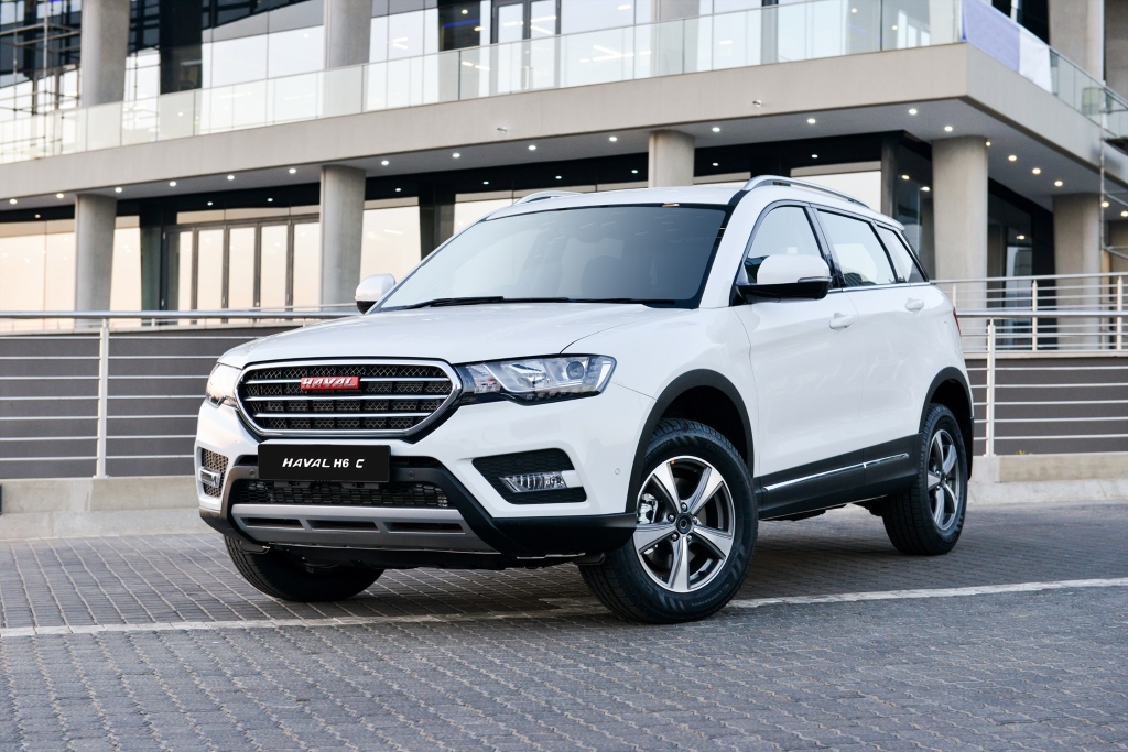 A White Haval H6C in a front of office complex