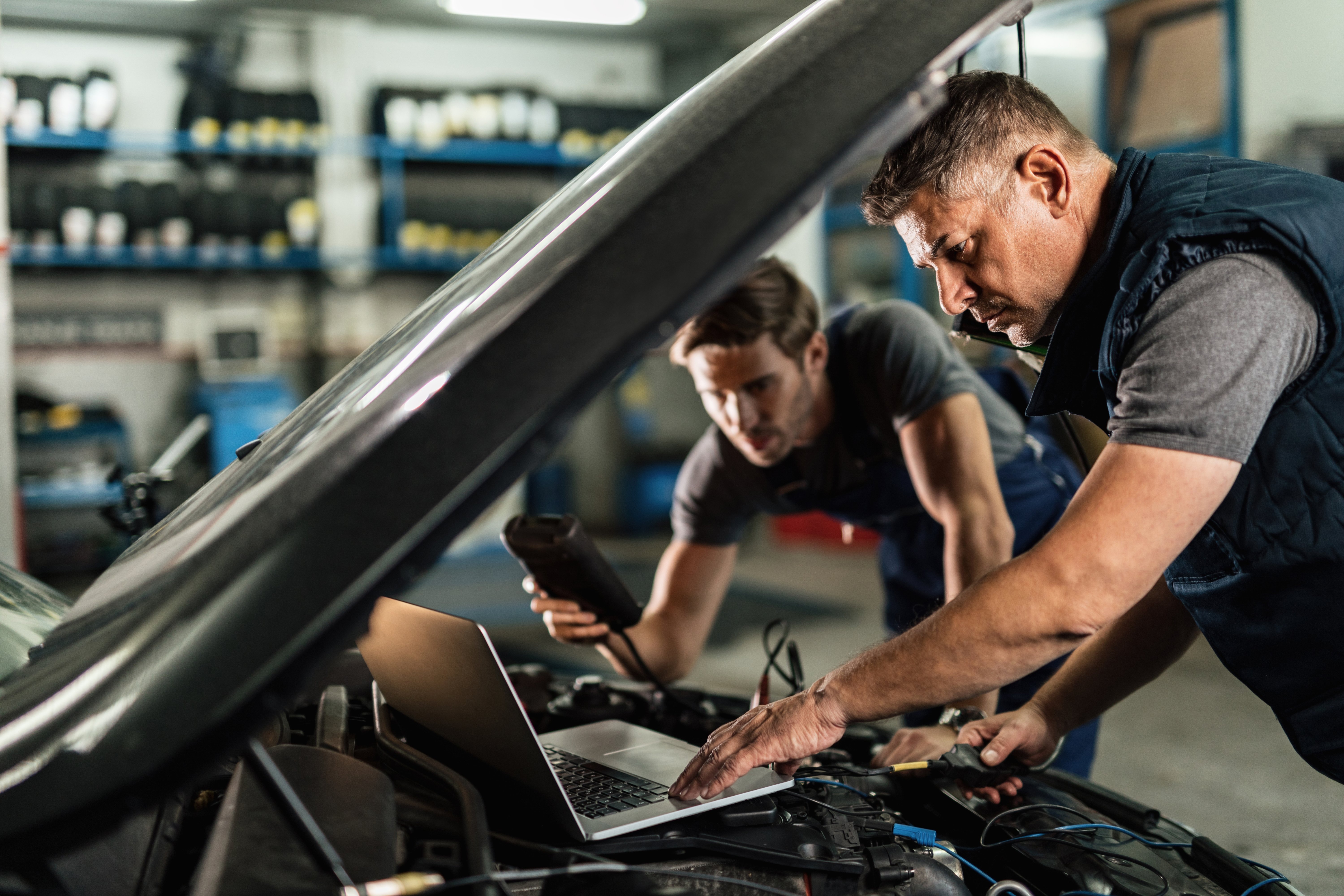Auto technicians working on car