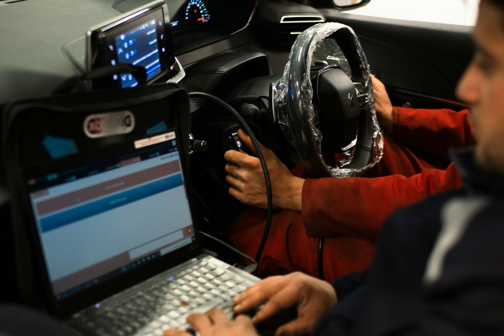 Auto technician in an electric car