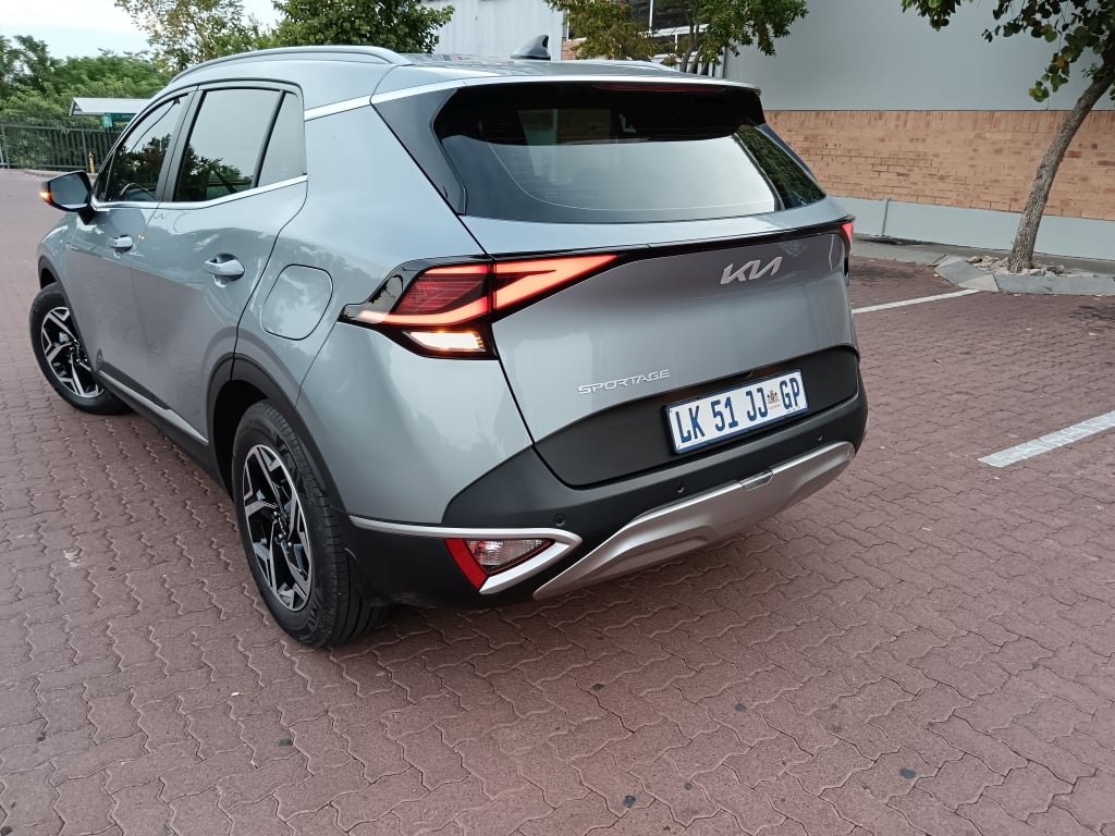 Rear view of a Sparkling Silver Kia Sportage LX in a parking lot