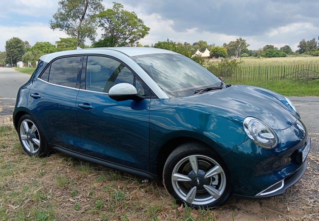 Side view of the GWM ORA 03 300 Super Luxury battery electric urban runabout on the road