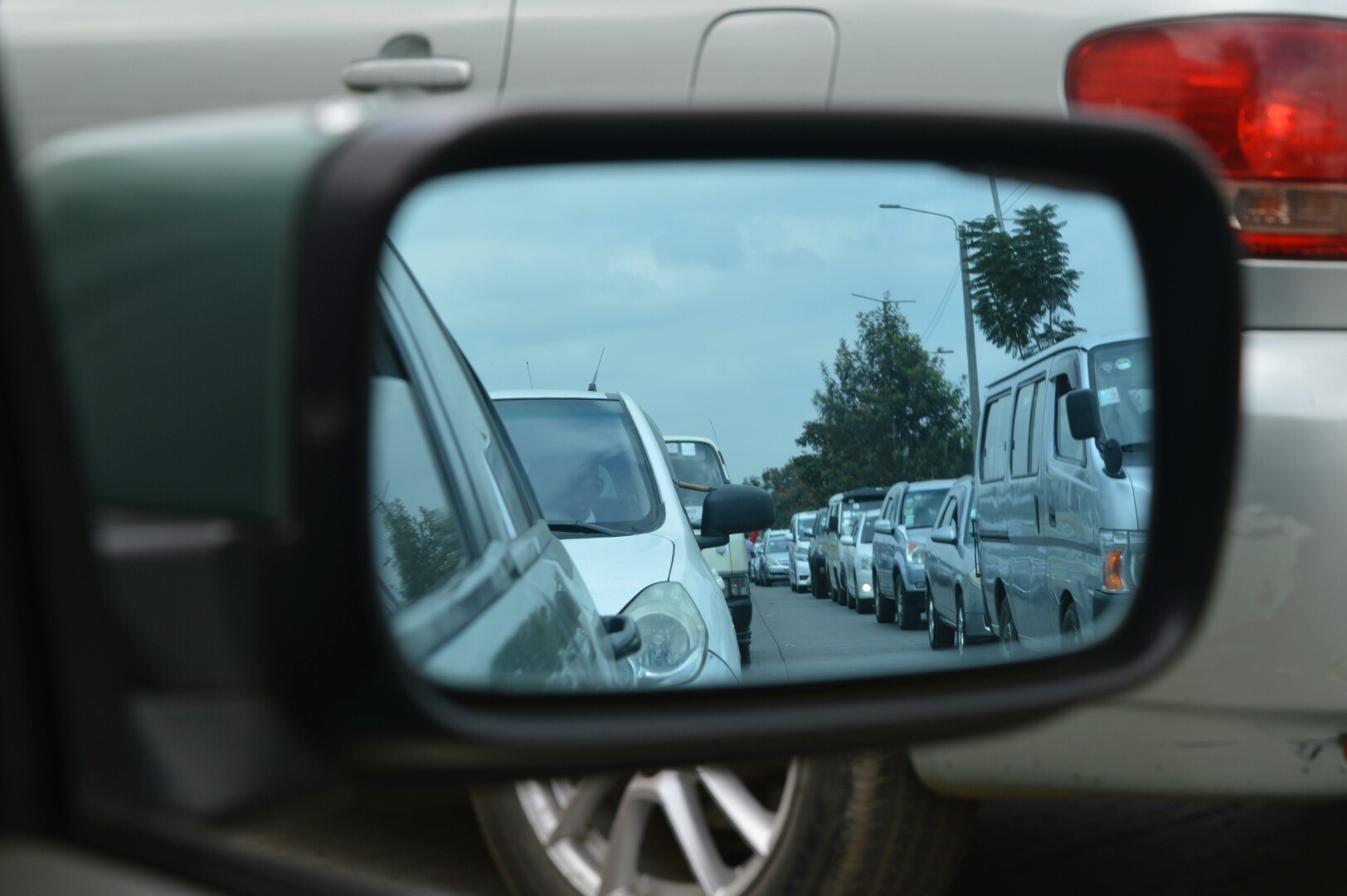 Traffic build up as seen through side mirror